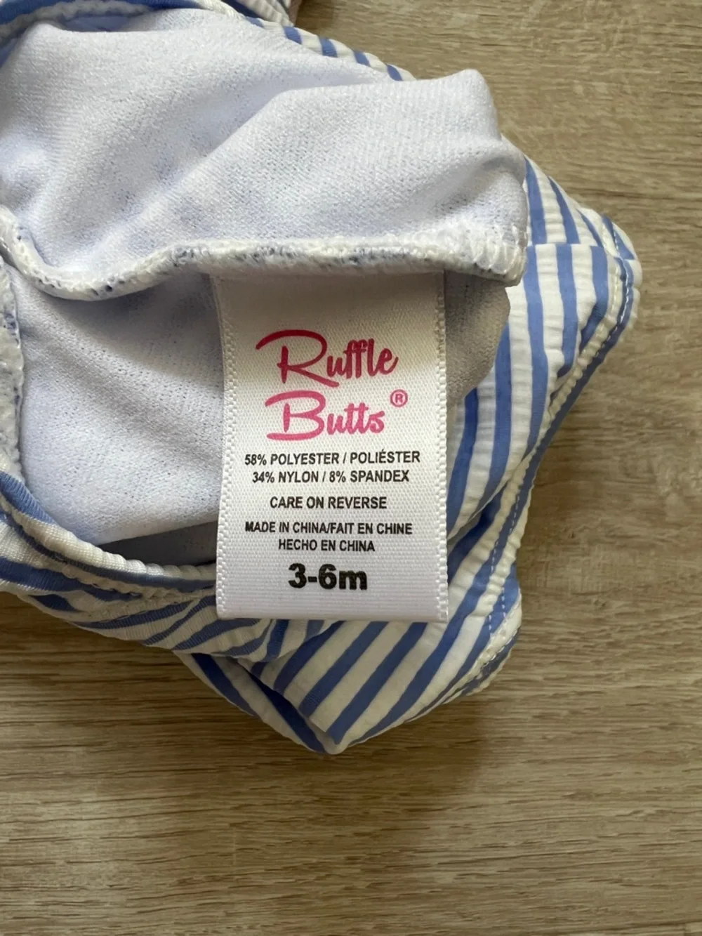 RuffleButts Waterfall Swimsuit Girls Seersucker Blue Stripe Ruffle Bow UPF50